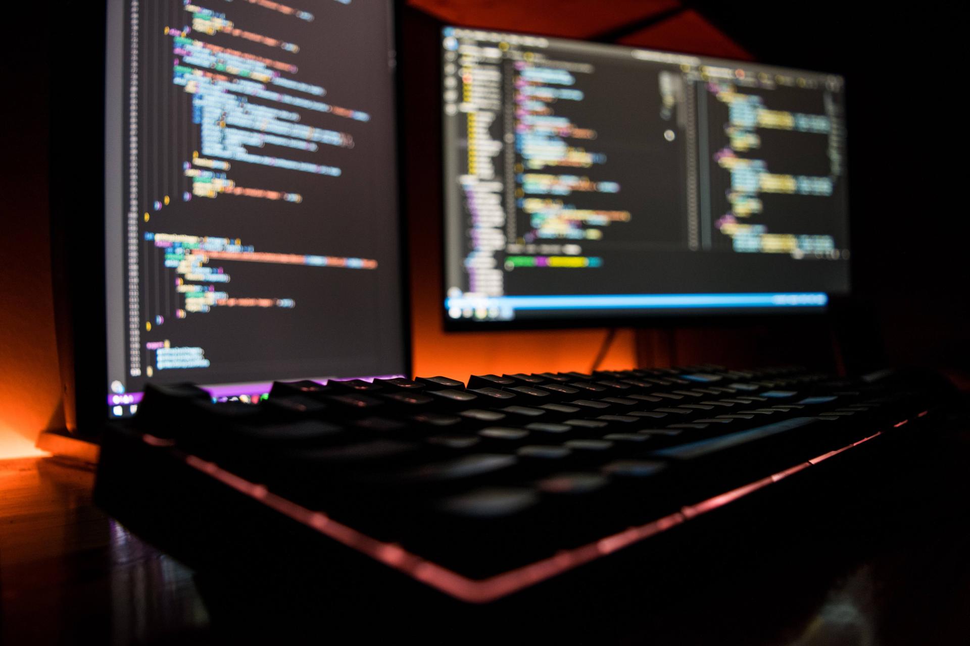desktop computer lit up in a dark room